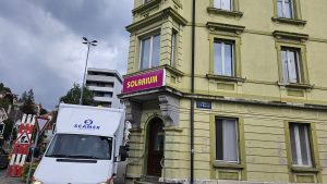Enseigne du solarium My Sun sur la façade d'un immeuble au Locle